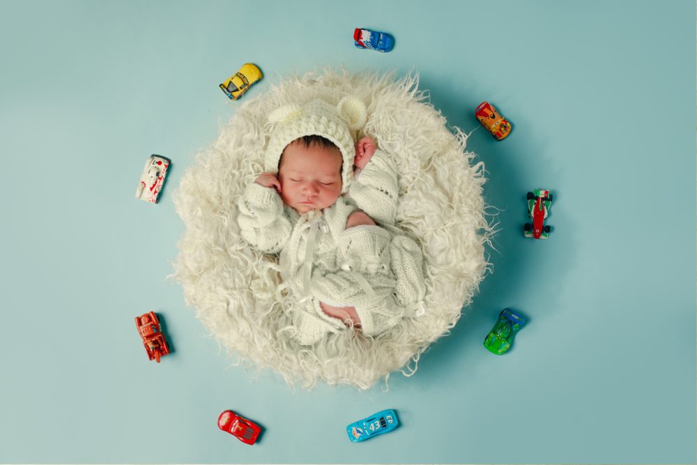 baby sleeping with toy cars
