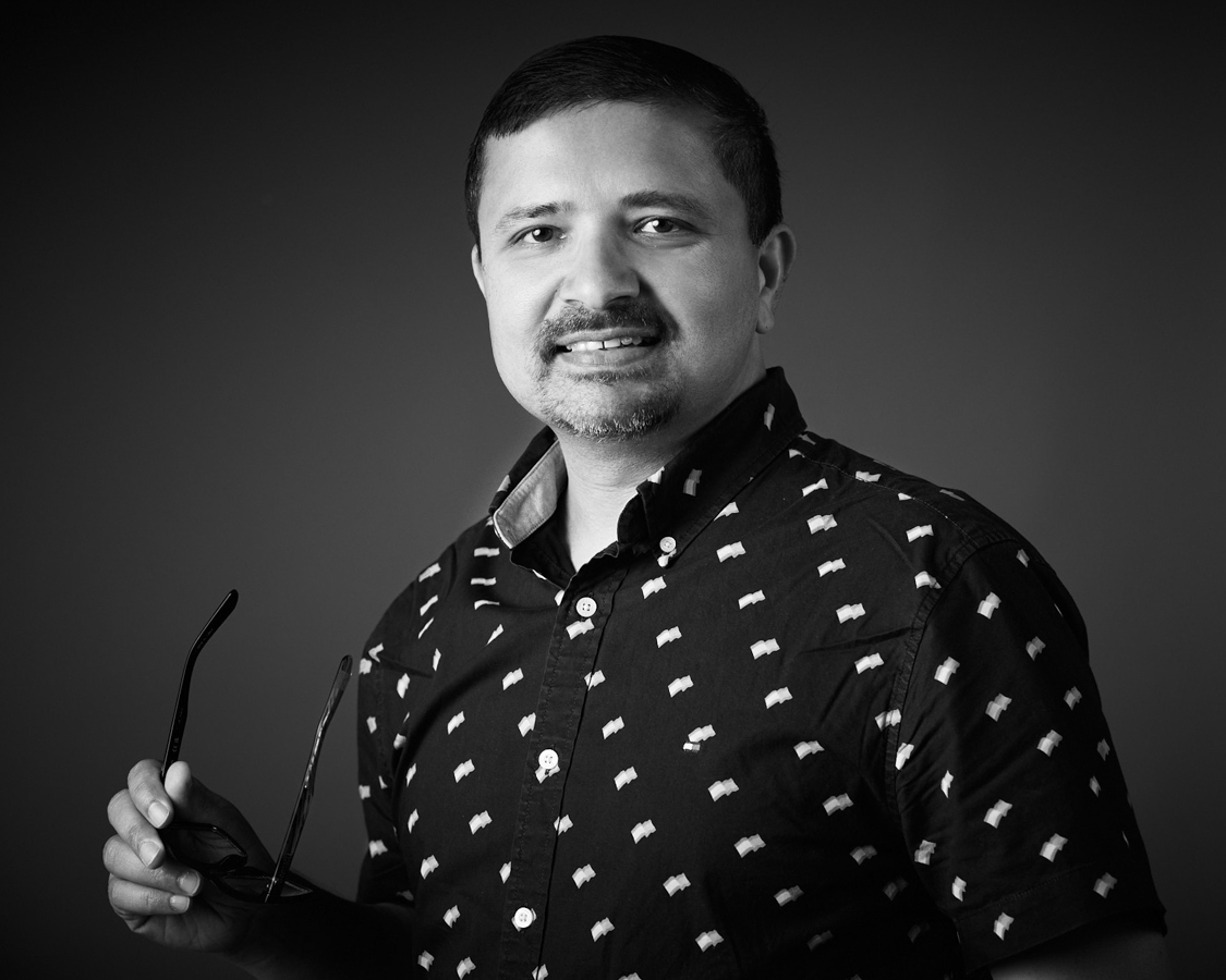 Bold black and white editorial headshot of an Adobe employee at the San Jose headshot booth